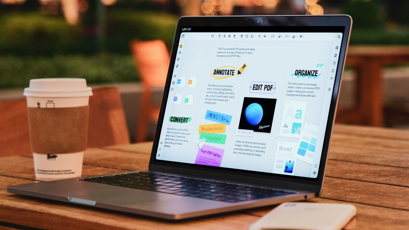 MacBook с программным обеспечением PDF на экране.  Это на столе снаружи.
